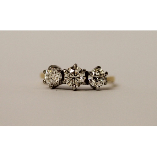 364 - A vintage three stone diamond ring, the three brilliant cut diamonds in claw setting on platinum and... 