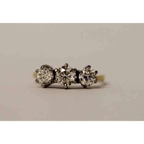 364 - A vintage three stone diamond ring, the three brilliant cut diamonds in claw setting on platinum and... 