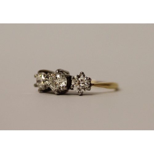 364 - A vintage three stone diamond ring, the three brilliant cut diamonds in claw setting on platinum and... 