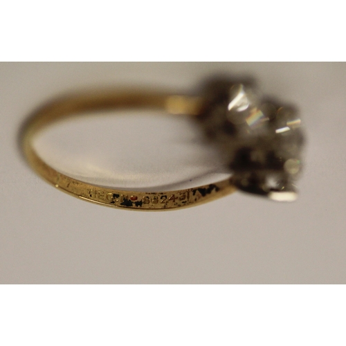 364 - A vintage three stone diamond ring, the three brilliant cut diamonds in claw setting on platinum and... 