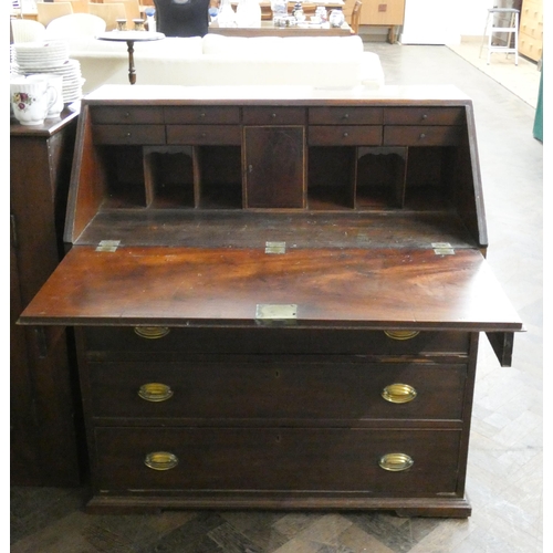 149 - A Georgian mahogany bureau with fitted interior and four long drawers under with brass handles, 38