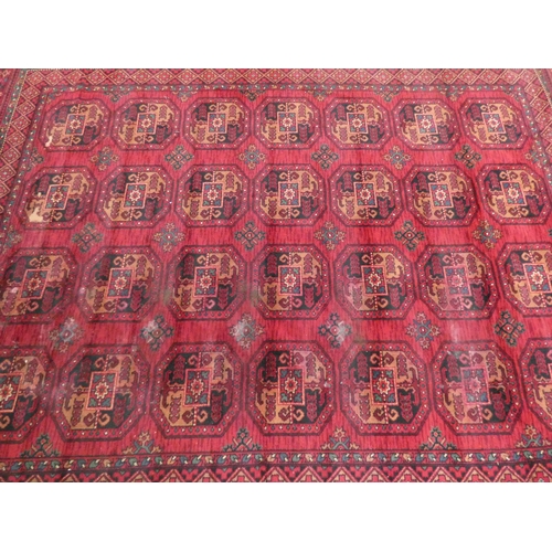 109 - A large red and pattered wool pile rug, 120