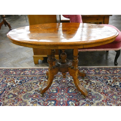 114 - An inlaid walnut oval coffee table on quadruple base