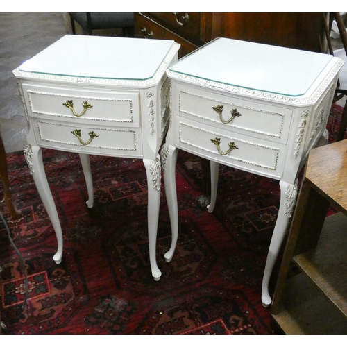 119 - A pair of white and gilt decorated bedside cabinets, each fitted two drawers standing on cabriole le... 