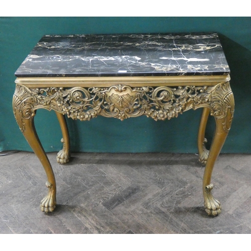 125 - A decorative gilt console table standing on paw feet with black mottled marble top, 34