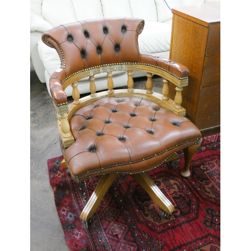 128 - A tub shaped swivel office elbow chair with brown buttoned leather upholstery