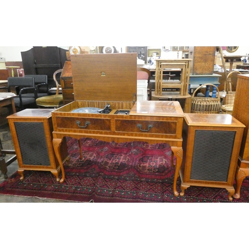 130 - A vintage Dynatron music system in a figured walnut cabinet on cabriole legs with two matching speak... 