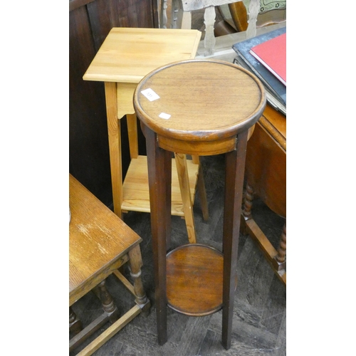 131 - A 1920's circular two tier mahogany plant pedestal and a modern pine plant pedestal