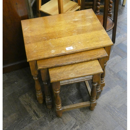 132 - A nest of three oak coffee tables of graduated size