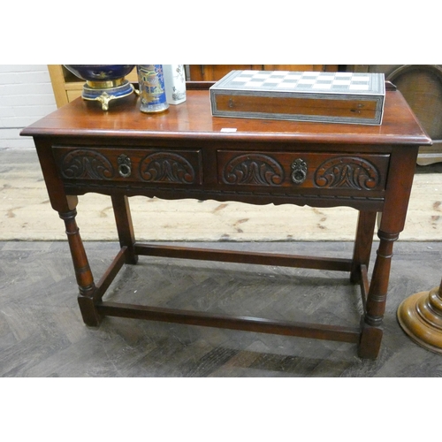 141 - An antique style oak hall table fitted two drawers