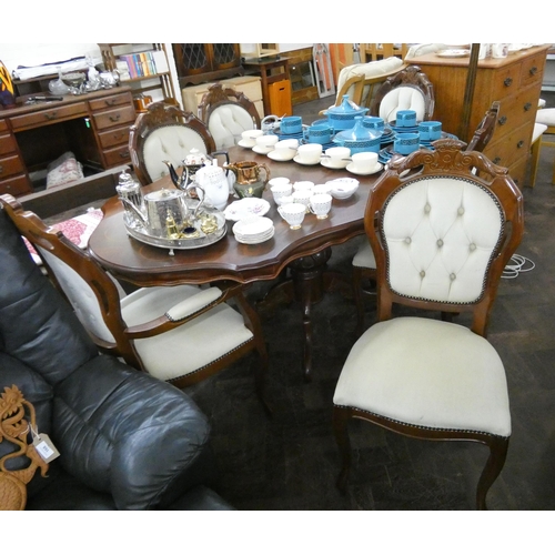 165 - An ornate Italian inlaid shaped top dining table and six matching chairs in buttoned fawn velvet