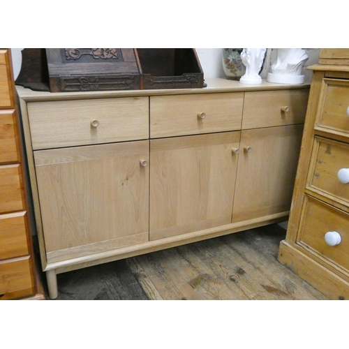 30 - A modern light oak low sideboard fitted three drawers and cupboards...