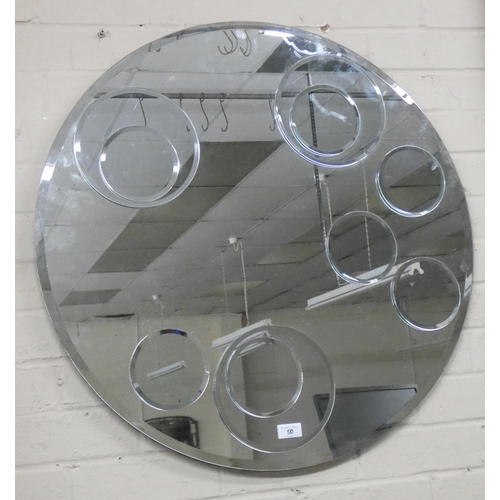 50 - A large circular bevelled frameless wall mirror with ring decoration, 2'6 diameter...