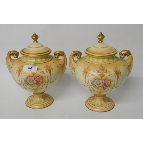 64 - A pair of Fielding's Crown Devon urn shaped vases with overs (one finial has been glued)