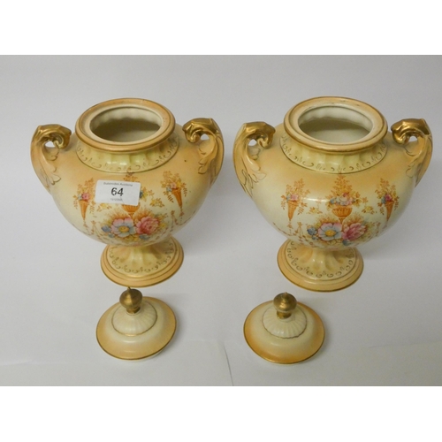 64 - A pair of Fielding's Crown Devon urn shaped vases with overs (one finial has been glued)