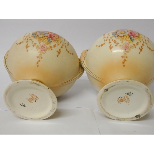 64 - A pair of Fielding's Crown Devon urn shaped vases with overs (one finial has been glued)