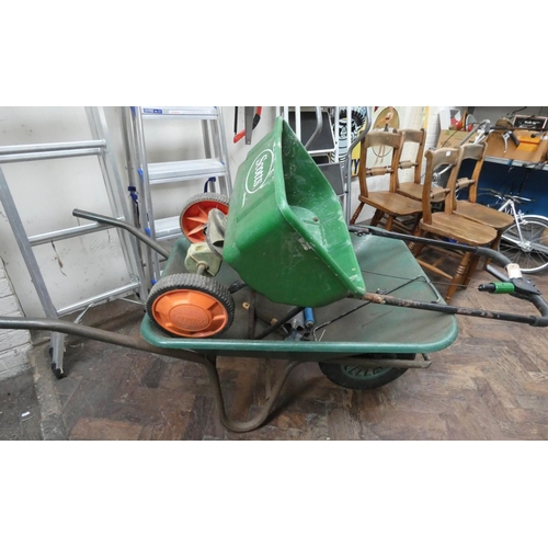 296 - A garden wheelbarrow and a garden seed spreader