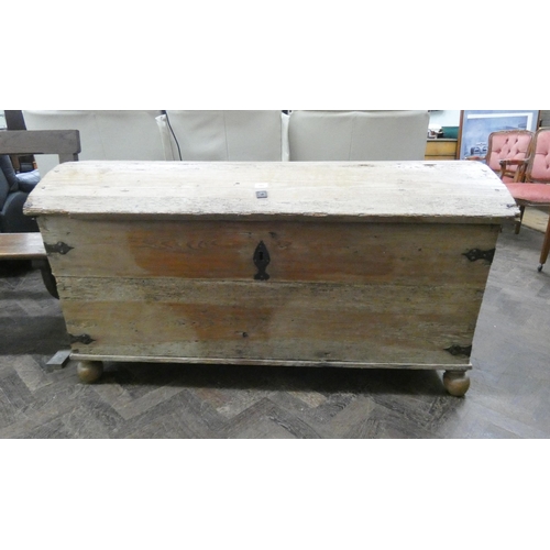 189 - An antique stripped pine dome topped storage trunk with iron lock, 56