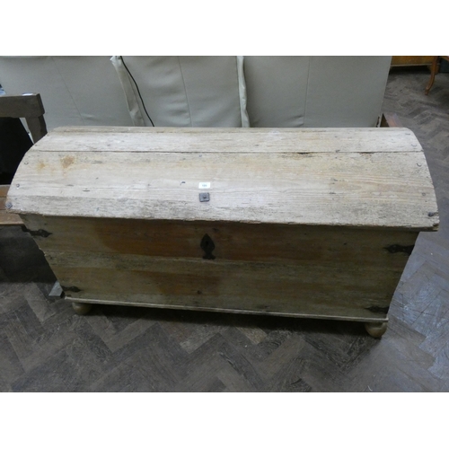 189 - An antique stripped pine dome topped storage trunk with iron lock, 56