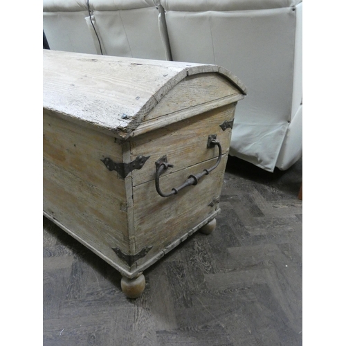 189 - An antique stripped pine dome topped storage trunk with iron lock, 56