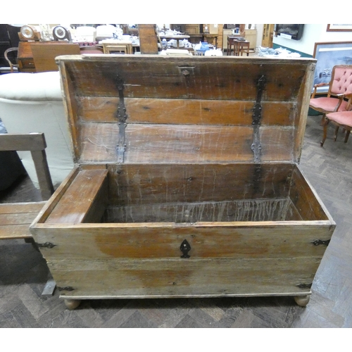 189 - An antique stripped pine dome topped storage trunk with iron lock, 56