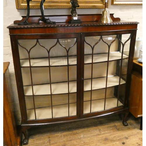 63 - A mahogany bow front glazed china display cabinet standing on claw and ball feet, 4' wide...