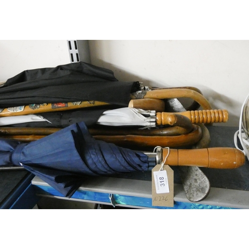 318 - Quantity of umbrellas, walking sticks, golf clubs etc