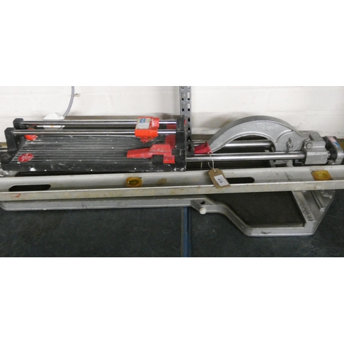 439 - A large tile cutter, a smaller tile cutter and a spirit level