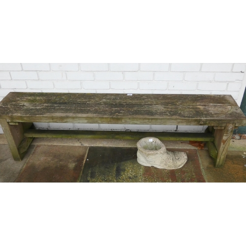 454 - A wooden backless garden bench and a reconstituted stone boot shaped planter