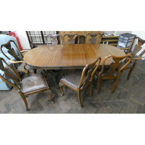 63A - A Georgian oval mahogany extending dining table with centre leaf and eight mahogany shield backed ch... 