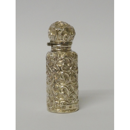 676 - A Victorian silver scent flask with embossed decoration, original stopper, in fitted box, maker Char... 