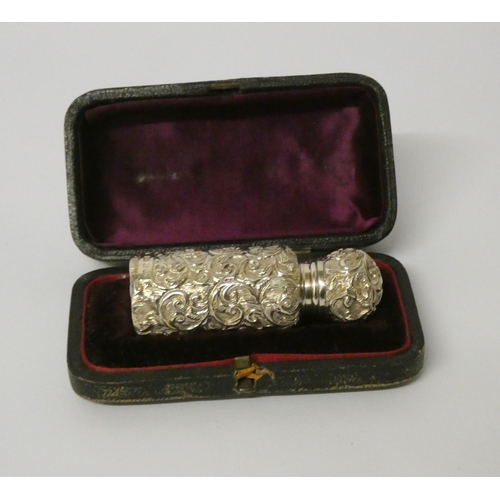 676 - A Victorian silver scent flask with embossed decoration, original stopper, in fitted box, maker Char... 