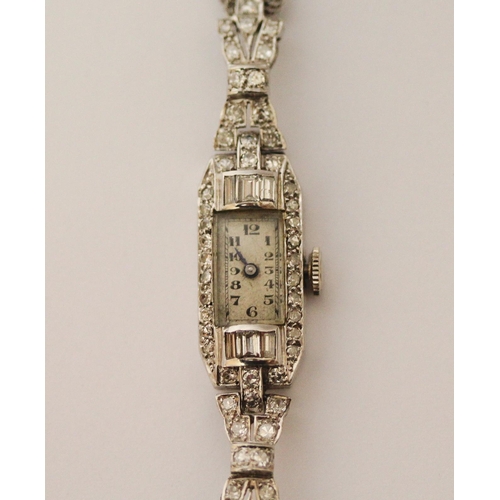 520 - An Art Deco diamond and platinum ladies cocktail watch, on hallmarked 9ct gold mesh strap. 17.5 cms ... 