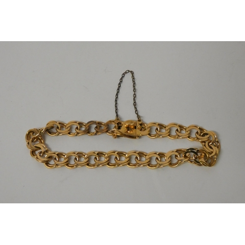 543 - A scrolled chain bracelet, foreign hallmarks, tests as 18ct gold. Weight 20.3g