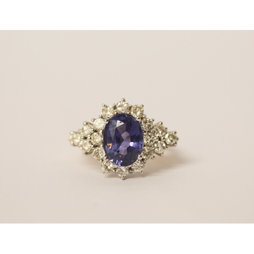 552 - A sapphire and diamond ring, the large oval sapphire estimated to weigh 4-4.5 carats, surrounded by ... 