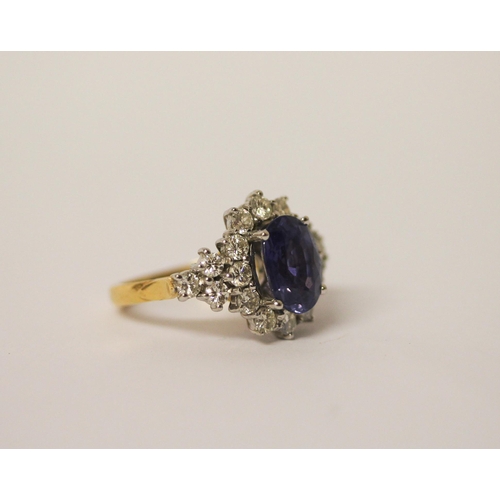 552 - A sapphire and diamond ring, the large oval sapphire estimated to weigh 4-4.5 carats, surrounded by ... 