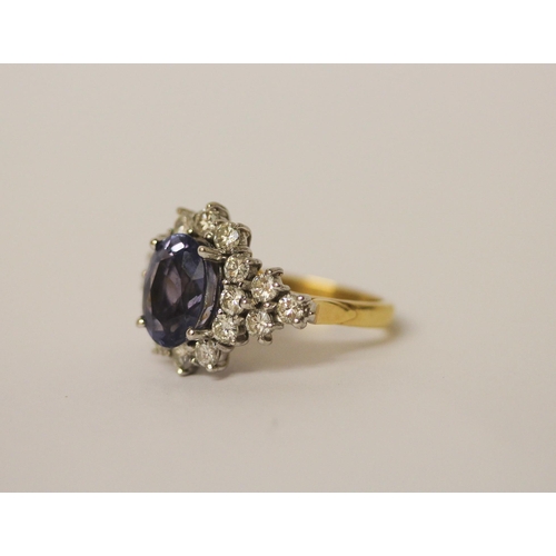 552 - A sapphire and diamond ring, the large oval sapphire estimated to weigh 4-4.5 carats, surrounded by ... 