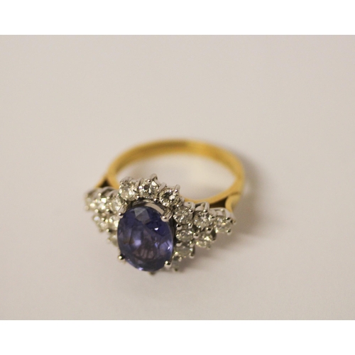 552 - A sapphire and diamond ring, the large oval sapphire estimated to weigh 4-4.5 carats, surrounded by ... 