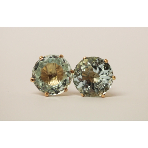 553 - A pair of large aquamarine stud earrings, the circular faceted aquamarines claw set in 18ct yellow g... 