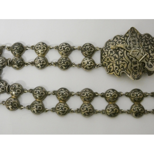 600 - A late 19th century Russian silver and niello waist belt and buckle, 70cms long approx, marked. 132g