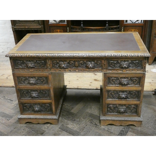 40 - Victorian lion mask carved dark oak office desk, nine drawers with leather top. 48