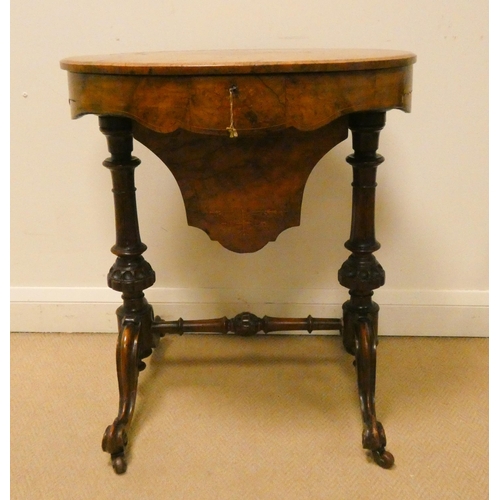 44 - Victorian oval inlaid walnut sewing box, the lift top section raised on turned stretcher base, 25