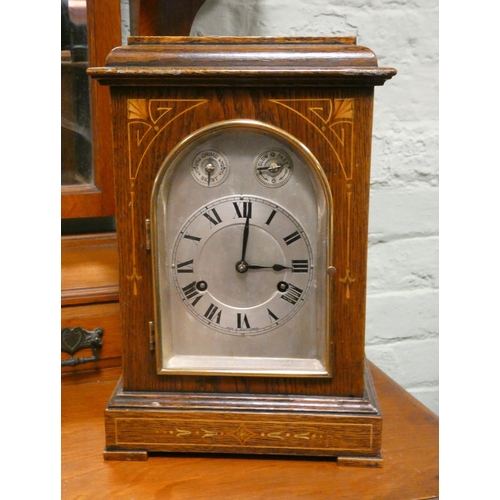 74 - Chiming bracket clock in inlaid oak case with silver arched dial