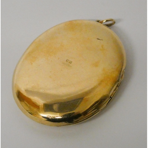 502 - Large oval 9ct gold locket, with engraved decoration  to the front. 57mm long including suspension l... 