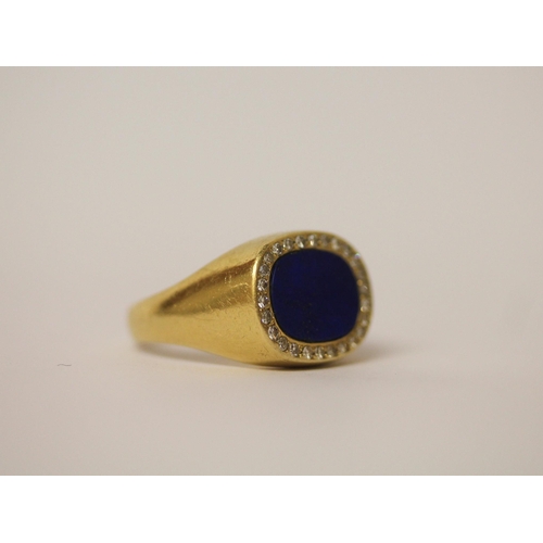 511 - A modern 18ct lapis lazuli and diamond oval panel signet style ring, shank marked 18k, ring size T. ... 