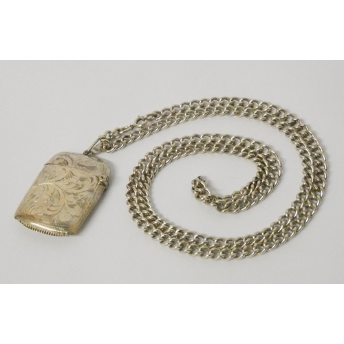 595 - A silver vesta case, mounted on a long silver chain. Gross weight 75g approx.