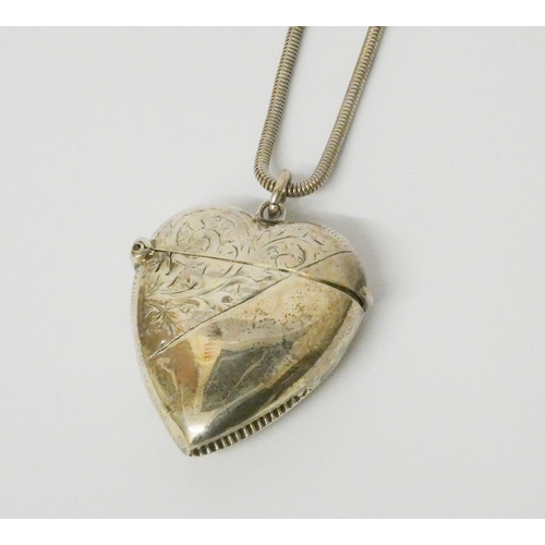 596 - A silver heart shaped vesta case on a long snake link chain. 25 grams