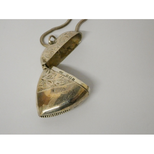 596 - A silver heart shaped vesta case on a long snake link chain. 25 grams