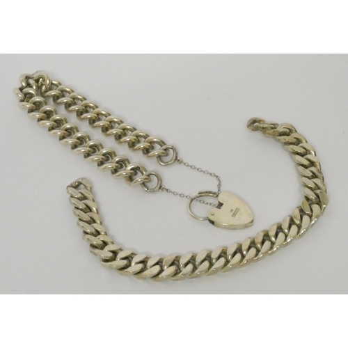 597 - A silver curb chain bracelet with heart shaped padlock fastening and a heavy gents silver bracelet. ... 