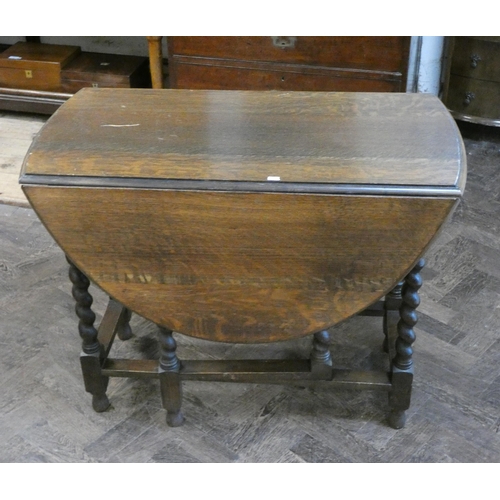 92 - An oval oak gate leg dining table on barley twist legs, 3' wide